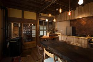 a large kitchen with a wooden table and chairs at Eye show - Vacation STAY 78363v in Tsukuba