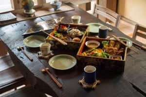 a table with a tray of food and plates of food at Eye show - Vacation STAY 78363v in Tsukuba +15 photos