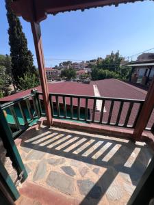 a wooden railing on a balcony with a view of a building at Famprika Volissos in Chios