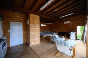 a living room with wooden walls and wooden floors at TOWA BEACH HOUSE IRITAHAMA - Vacation STAY 06102v in Shimoda +15 photos