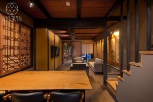 a conference room with a wooden table and chairs at Kyoran-Gion Residence - Vacation STAY 09383v in Gionmachi