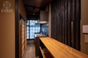 a kitchen with a wooden counter and a sink at Kyoran-Gion Residence - Vacation STAY 09383v in Gionmachi