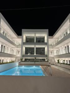 a large building with a swimming pool in front of it at Diamond 3 in Kallithea Halkidikis