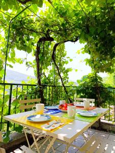 a white table with plates and utensils on it at La Casa del Sole in Carrodano Inferiore