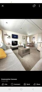 a room with two beds and a living room with a table at Ascot at Lochlands in Forfar