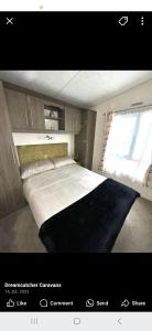 a bedroom with a large bed with a window at Ascot at Lochlands in Forfar