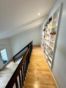 a staircase with white walls and wooden floors at Fully furnished cozy home in Montreal +14 photos
