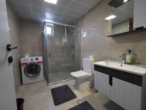a bathroom with a shower and a toilet and a sink at MEY Apart in Kaş +30 photos
