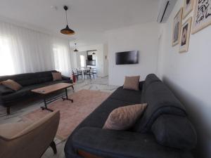a living room with a couch and a table at MEY Apart in Kaş