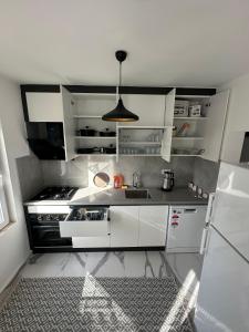 a kitchen with white cabinets and a sink at MEY Apart in Kaş