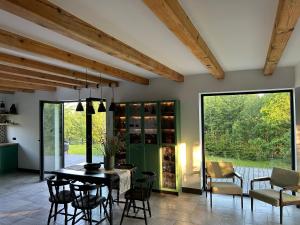 a dining room with a table and some chairs at Powidoki Mazury in Płociczno