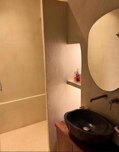 a bathroom with a black sink and a shower at Alemarni Syros in Ermoupoli +9 photos
