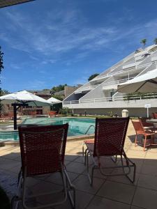 two chairs sitting next to a swimming pool at Varandas Praia de Ponta Negra in Natal
