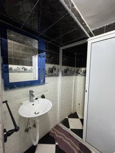 a bathroom with a sink and a mirror at Appartement Vue Mer Tamraght in Tamraght Ou Fella +14 photos