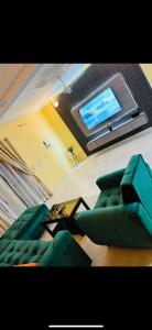a living room with a couch and a tv at Perfect Home in Ouagadougou