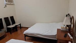 Ένα ή περισσότερα κρεβάτια σε δωμάτιο στο Green Forest Homestay
