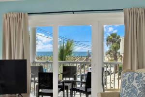 a screened in porch with a view of the ocean at Oceanview on Tybee 202-1 in Tybee Island