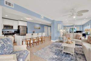 a living room and kitchen with a couch and a table at Oceanview on Tybee 202-3 in Tybee Island