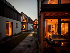 a house with sliding glass doors and a patio at PURA new Seaside Jacuzzi Houses in Trzęsacz +25 photos