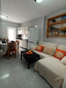 a living room with a couch and a table at Apartamento Brañas in Cambados