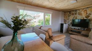 a living room with a vase of flowers on a table at Torreón El Guindal - Sierra de Gredos in Mijares