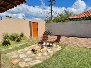a patio with two chairs and a fire pit at BayShore Loft in Cabo Frio