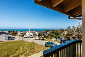 a view of the ocean from the balcony of a house at Beachcomber Monthly Only in Cambria