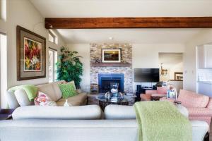 a living room with a couch and a fireplace at Beachcomber Monthly Only in Cambria