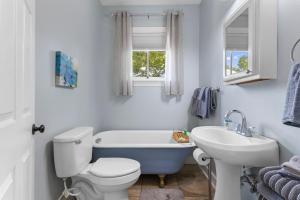 un bagno con un water bianco e un lavandino di Gulfport Game Room House Walk to Beach Family Fun a Gulfport Altre 30 foto