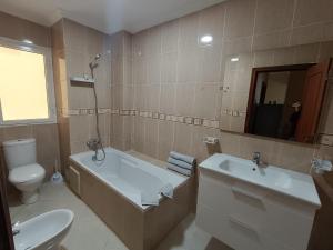 a bathroom with a tub and a toilet and a sink at Cozy appartement in Tangier in Tangier