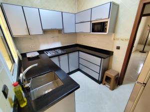 a small kitchen with a sink and a counter top at Cozy appartement in Tangier in Tangier +6 photos
