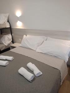 a bed with two white pillows and towels on it at bed end breakfast scalea da romina in Scalea +2 photos