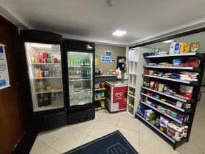 a store with two refrigerators in a room with food at Loft 306 Imperial Suites in João Pessoa