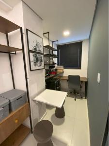 an office with a desk and a chair in a room at Apartamento 107 Hotel Novo Centro in Petrolina