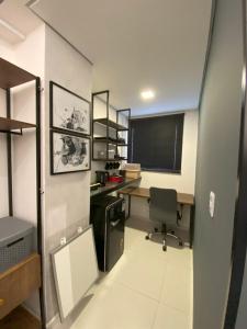 an office with a desk and a chair in a room at Apartamento 107 Hotel Novo Centro in Petrolina
