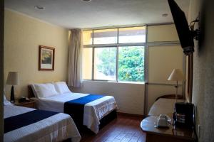 Postel nebo postele na pokoji v ubytování Hotel Calli