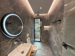 a bathroom with a sink and a mirror at Hotel AURA in Sarandë +151 photos