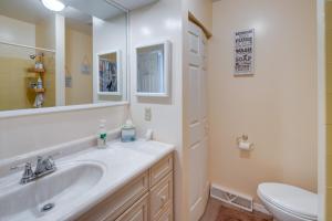 a bathroom with a sink and a toilet and a mirror at Walk to Brigantine Beach Condo with Furnished Patio in Brigantine +18 photos