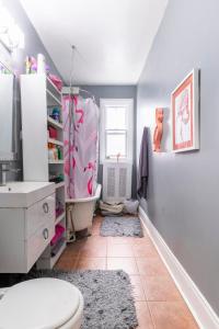 a bathroom with a toilet and a sink at Huge King Room in 3 BedRoom Great Location Downtown Mtl in Montréal