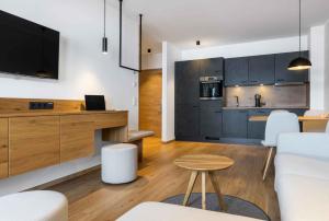 a kitchen and living room with a couch and a table at Apartment in Lam - Bayerischer Wald 50007 in Lam +26 photos