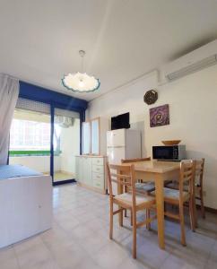 a kitchen and dining room with a table and chairs at Apartment in San Michele al Tagliamento 45664 in San Michele al Tagliamento