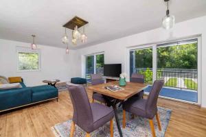 a living room with a table and a blue couch at Holiday home in Tribalj 51443 in Tribalj