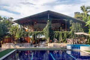 a resort with a swimming pool and a building at Hotel Kipara in El Valle