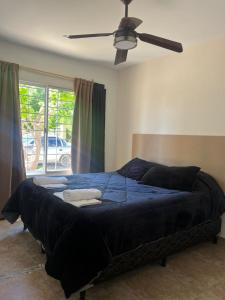 a large bed in a bedroom with a ceiling fan at La casa de Beatriz Paz, confort y tranquilidad in San Rafael