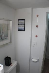 a bathroom with a toilet and a picture on the wall at Southend Gem in Hartford