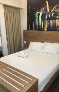 a bedroom with a large bed with a view of a bridge at Águas Claras in Brasilia