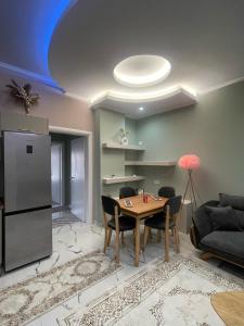 a kitchen and dining room with a table and a refrigerator at The Star House in Pogradec +12 photos
