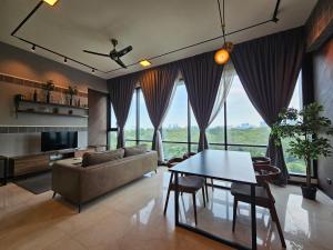 a living room with a couch and a table at Opus Residences by Star Haven in Kuala Lumpur