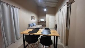 a living room with a table and chairs in a room at Departamento 3 in Santa Rosa