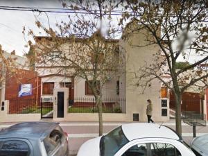 a white car parked in front of a building at Departamento 3 in Santa Rosa